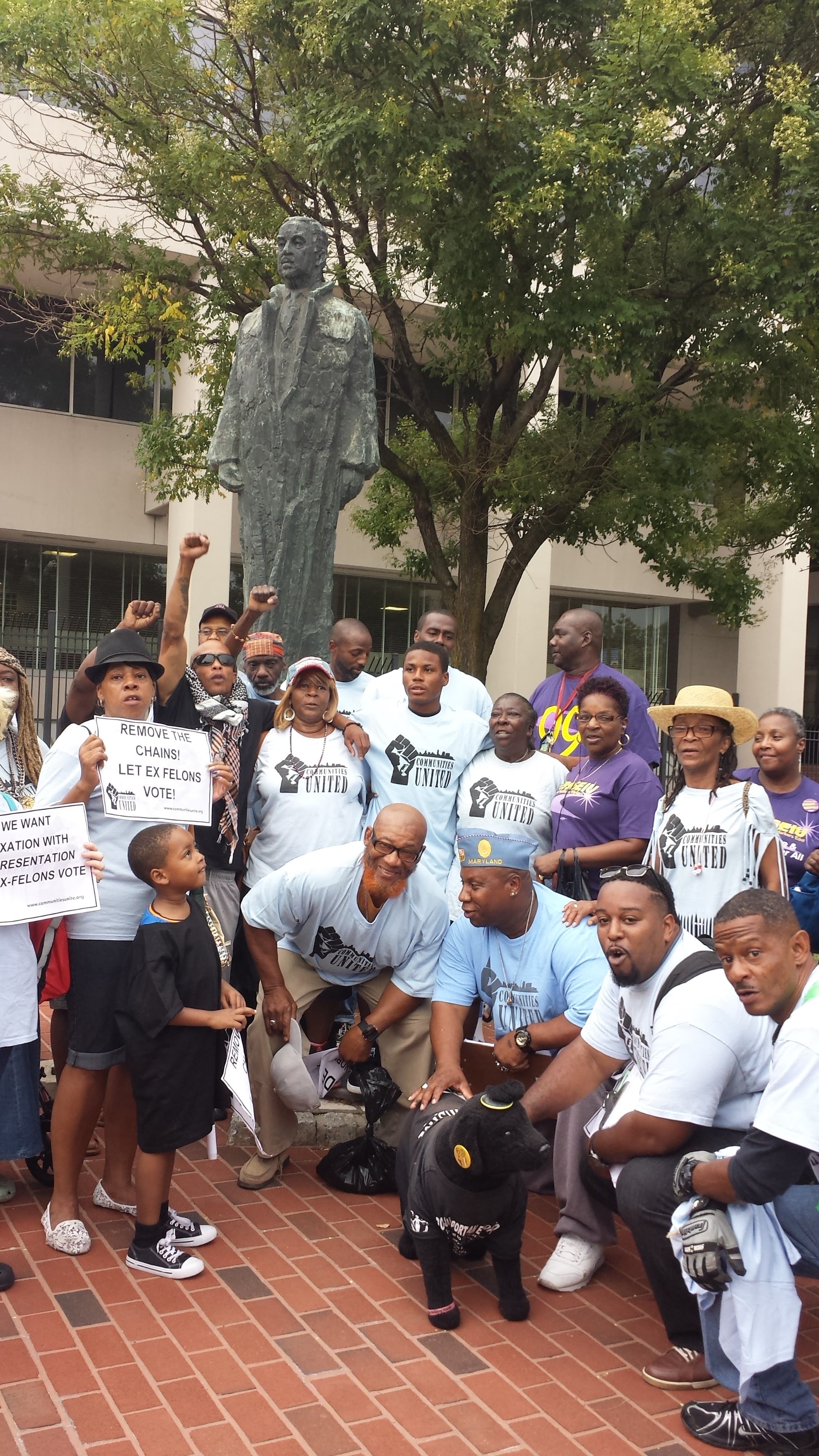 Group photo of Communities United members outside with statue
