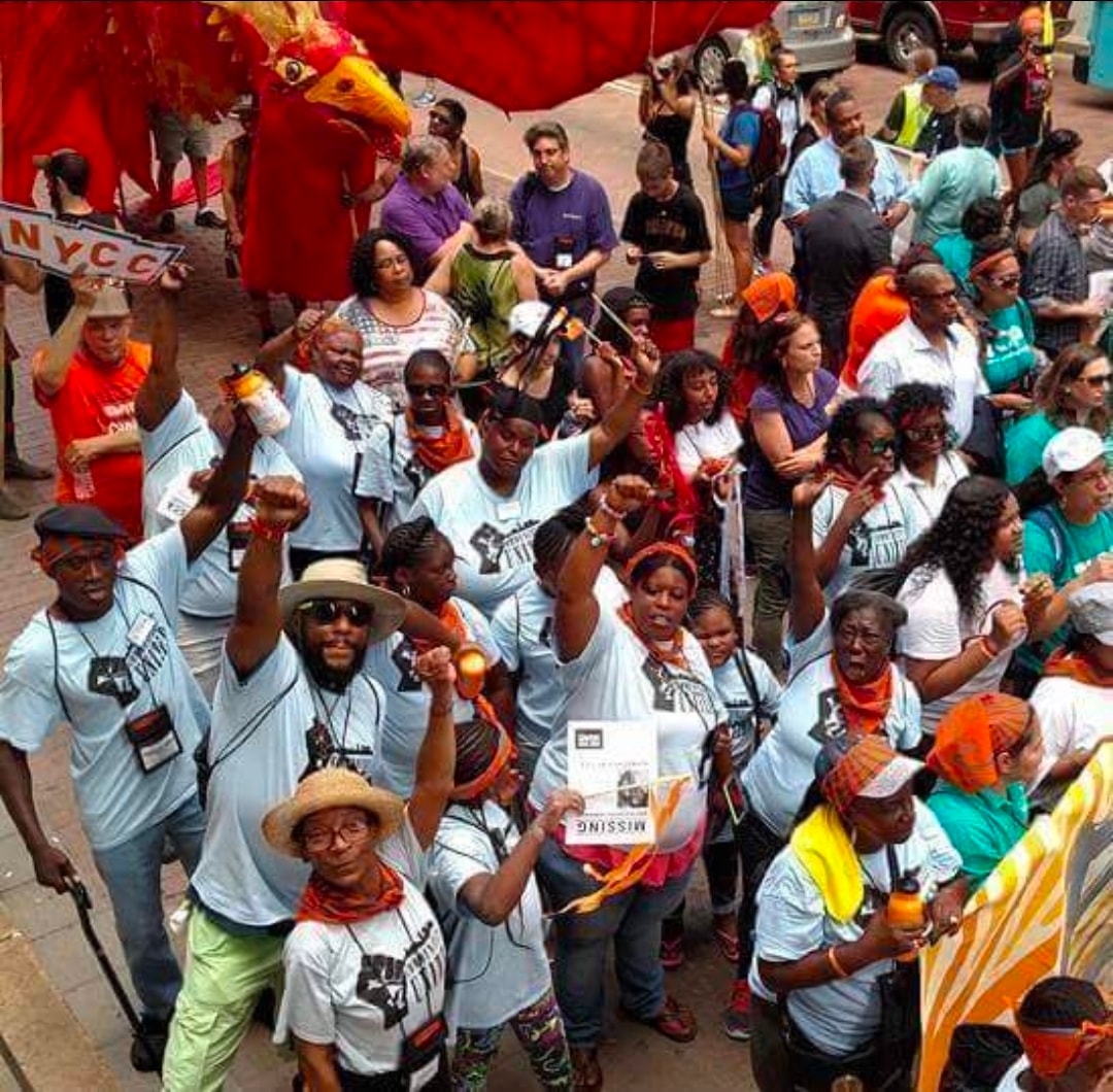 Communities United members marching with raised fists at street parade